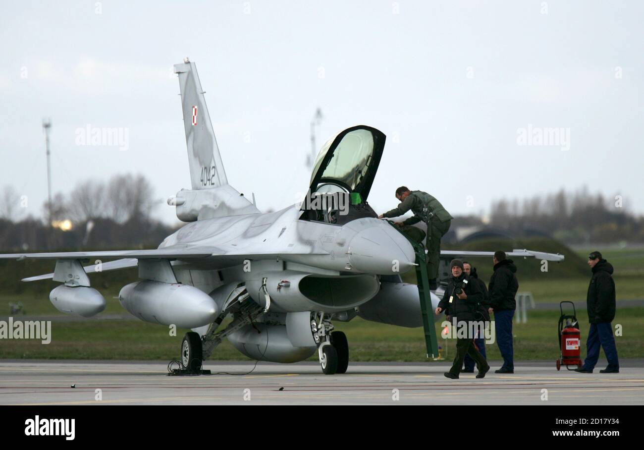 A pilot gets off one of the first Polish Air Force F-16 fighter jets that  arrived at the Krzesiny airport in western Poland, near the city of Poznan  November 9, 2006. The
