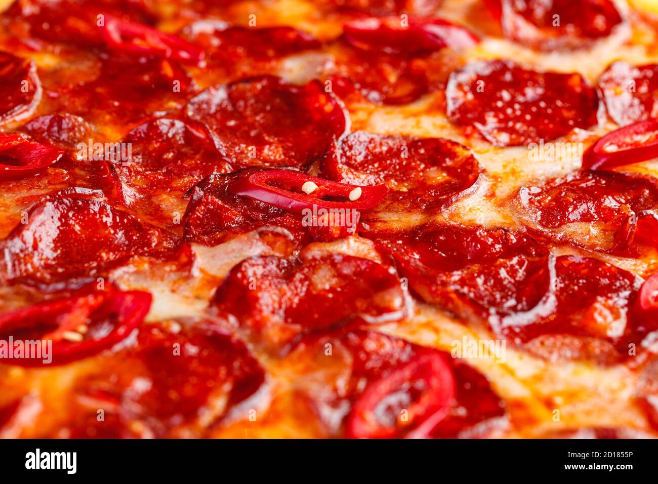 Pepperoni pizza on wooden board on a dark background. Close-up Stock Photo