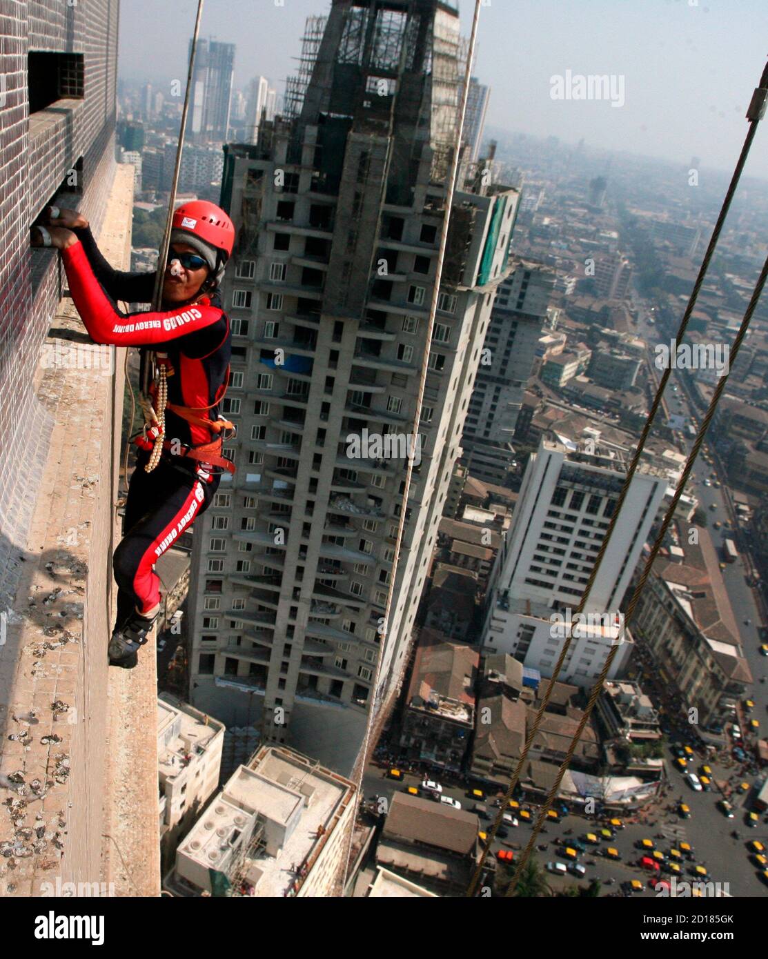 Gaurav Sharma, a martial arts trainer, climbs the 45 storey 'Shreepati  Arcade' in Mumbai January 26, 2009. Sharma climbed the city's tallest  building, at 500 feet (152 meters), as a tribute to