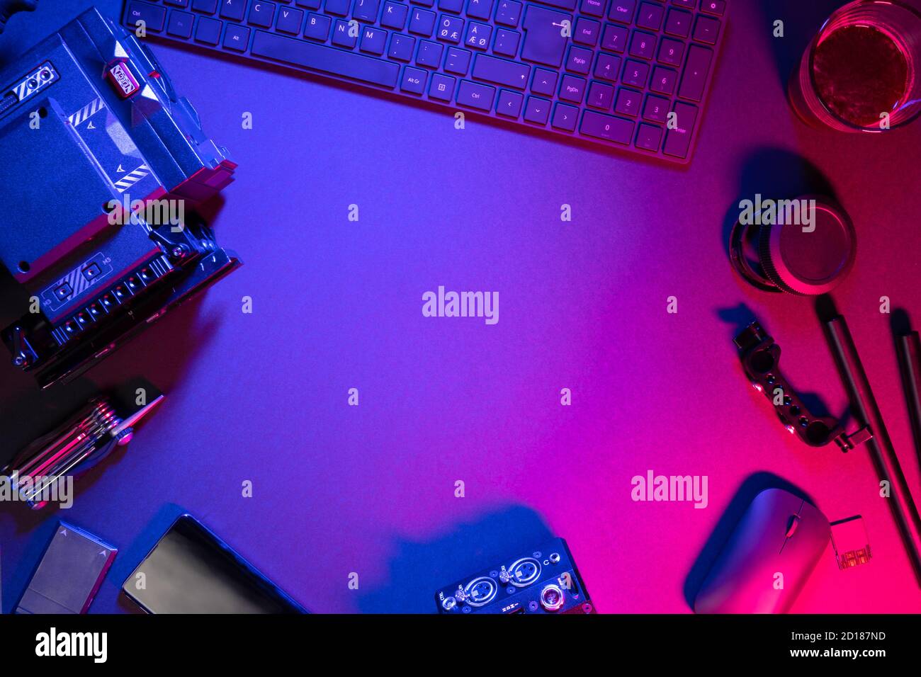 Overhead view of computer parts coffee and video camera on illuminated table Stock Photo