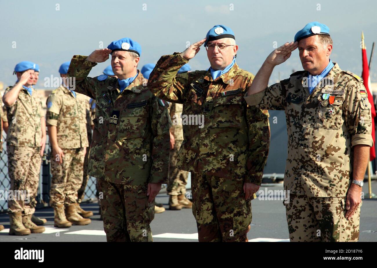 United Nations Interim Force in Lebanon (UNIFIL) Commander Claudio Graziano  (C), Germany?s Rear Admiral Juergen Mannhardt (R) and Rear Admiral Paolo  Sandalli of Italy (L) salute during a handover ceremony aboard German