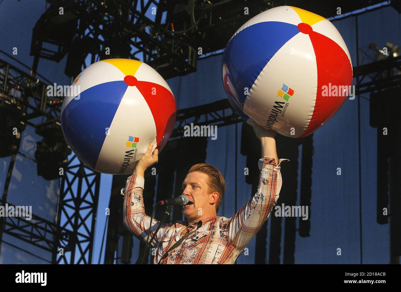 Josh Homme from the music group Queens of the Stone Age holds up inflatable  balls as he commends the residents of New Orleans on their resilience  during the Voodoo Music Experience concert