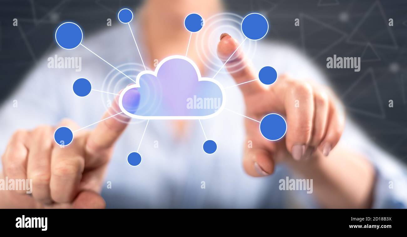 Woman touching a cloud networking on a touch screen with her fingers ...