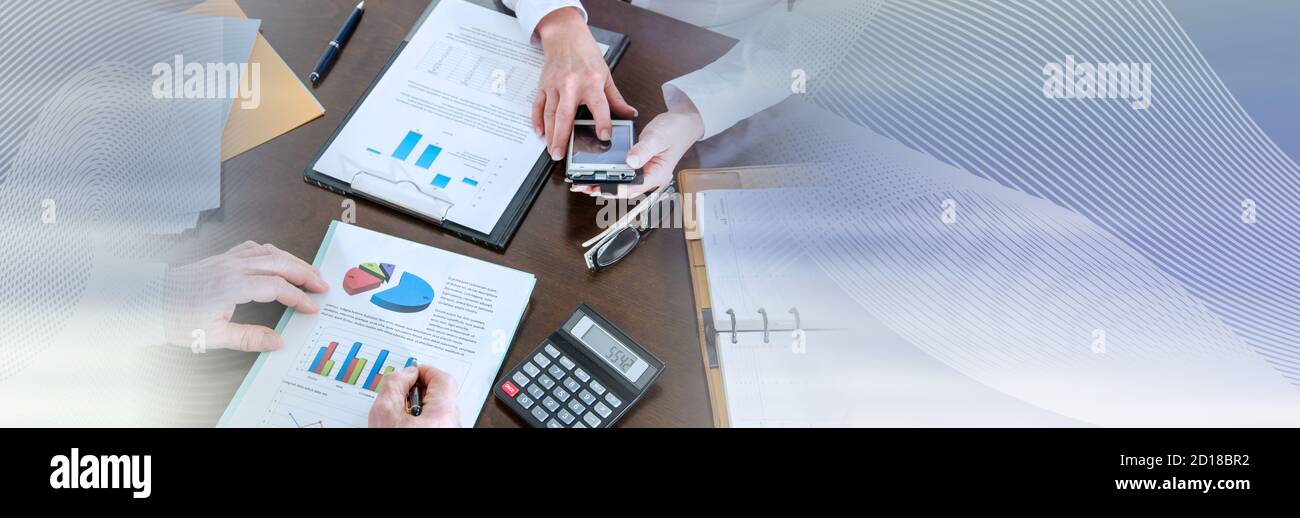 Two business people analyzing charts; panoramic banner Stock Photo - Alamy