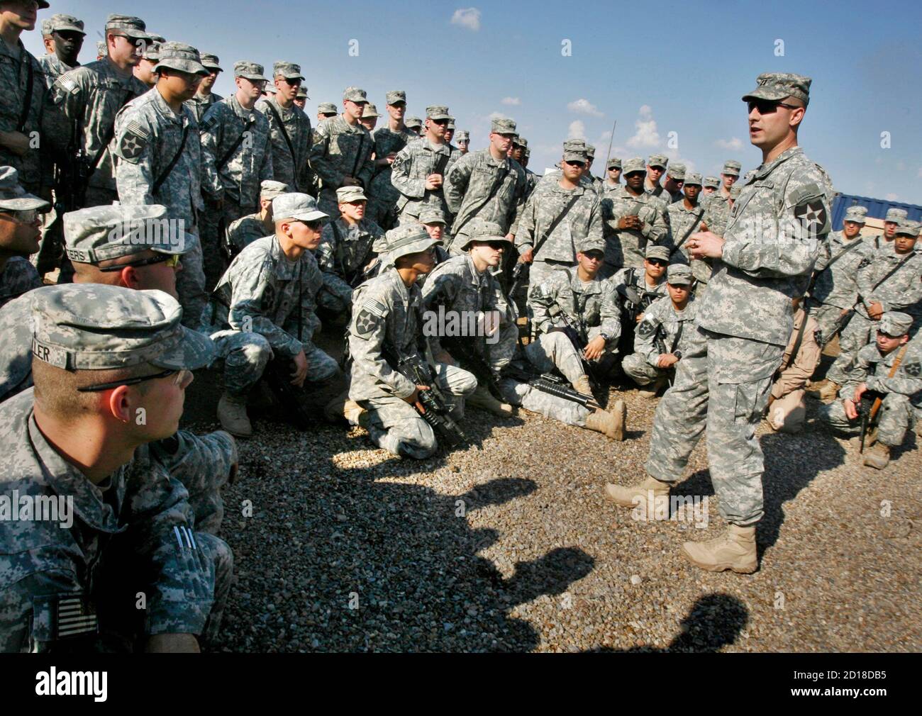 U.S. Army Captain Stephen Phillips (R), the commanding officer of Charlie Company, 2-3 Infantry, tells his troops their tour of Iraq is being extended for at least 90 days, at Taji Air Base north of Baghdad April 12, 2007. REUTERS/Bob Strong (IRAQ) Stock Photo