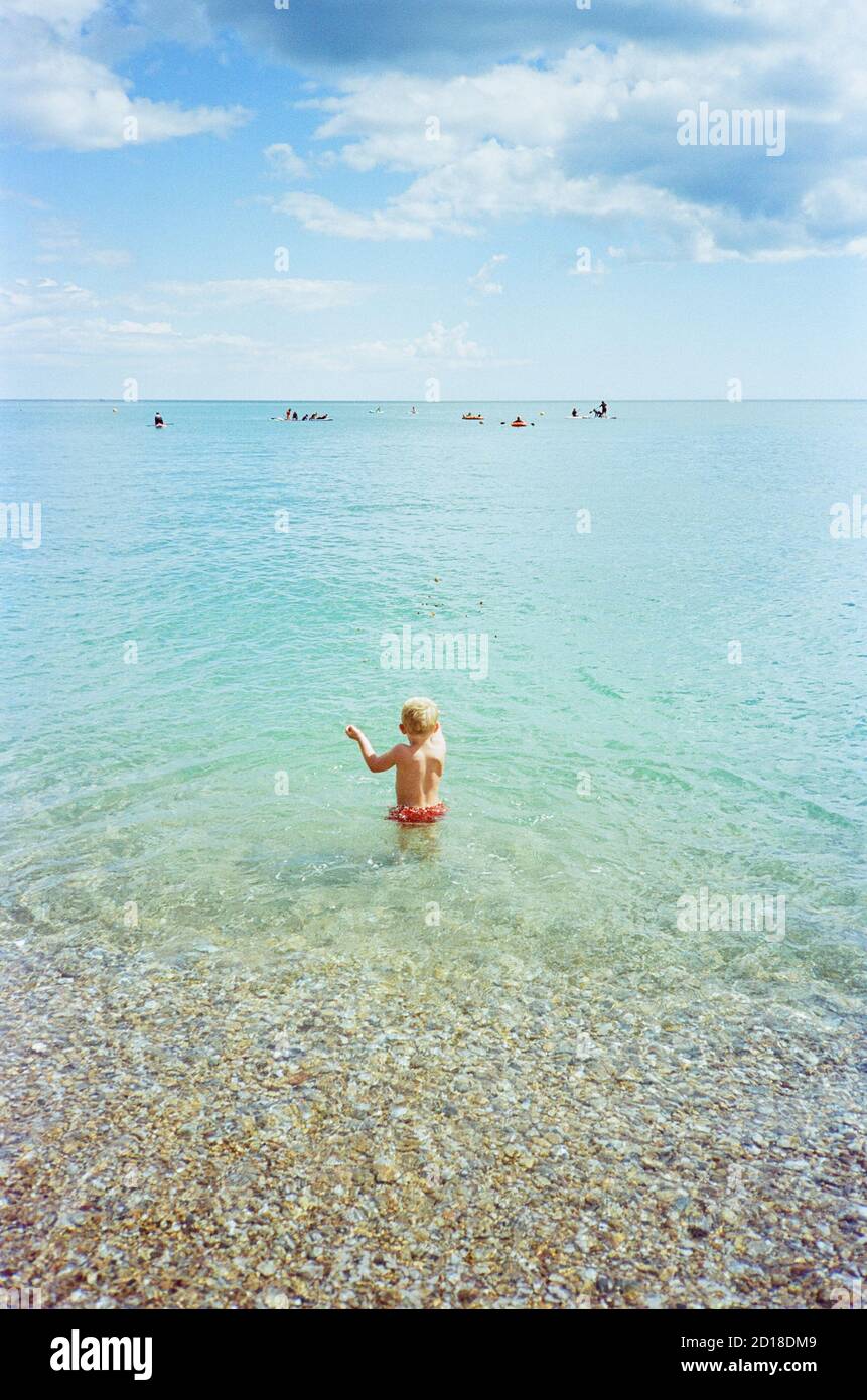 Three year old boy swimming at Blackpool Sands Beach, Dartmouth , Devon, England, United Kingdom. Stock Photo