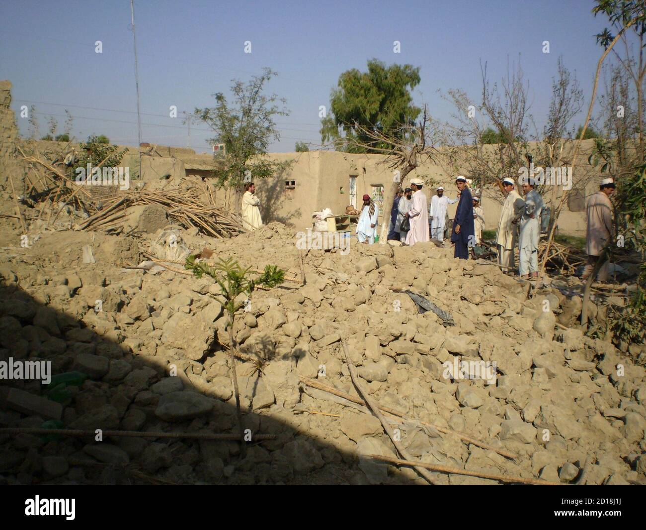 Tribesmen gather at a site of a missile attack on the outskirts of Miranshah, near the Afghan border, October 12, 2008. Suspected U.S. drones fired two missiles on Saturday into a Pakistani region regarded as a safe haven for al Qaeda and Taliban militants, killing at least five insurgents, residents and an intelligence official said. REUTERS/Haji Mujtaba (PAKISTAN) Stock Photo