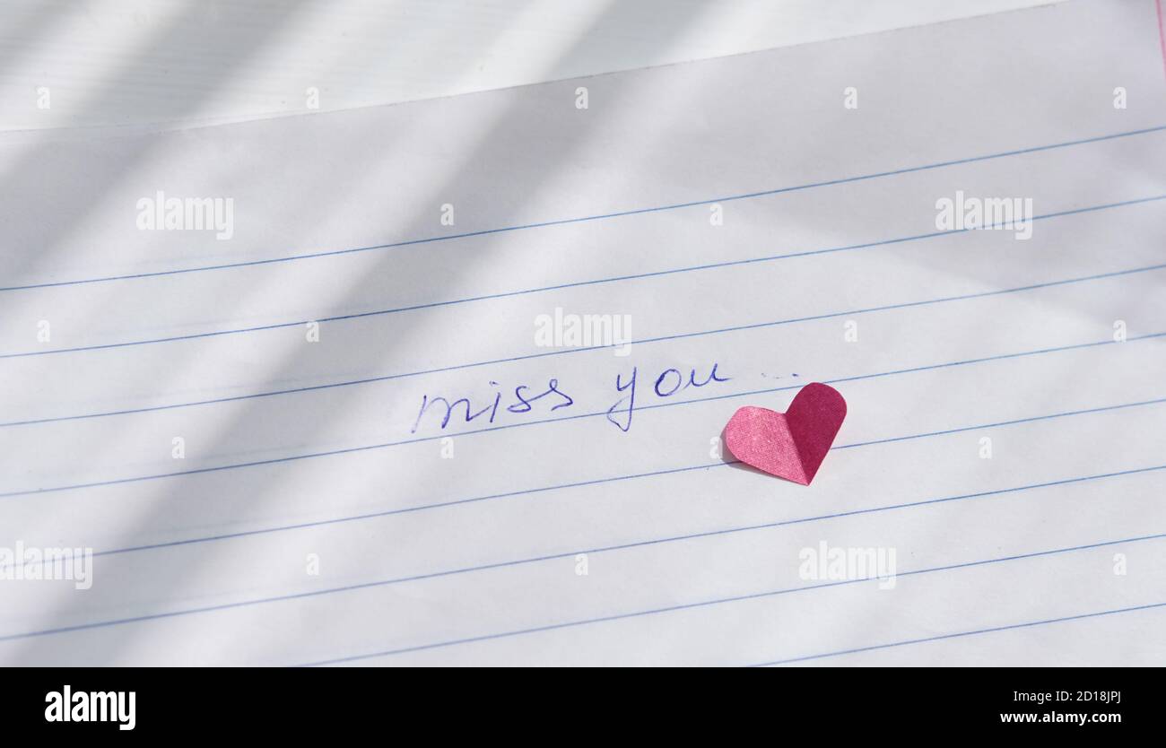 miss you note hand written on a paper. love letter with paper ...