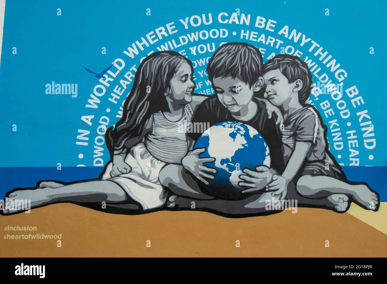 WILDWOOD, NEW JERSEY - September 17, 2020: A Painting of Three Children Holding a Globe With the Concept of Equality on the Wildwood Boardwalk Stock Photo