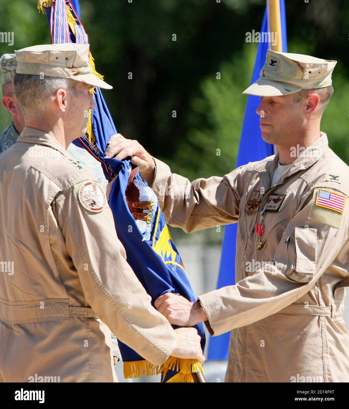 Mike Hostage (L), Commander, U.S. Air Force Central Command, Southwest Asia, and Colonel Blaine Holt take part in the handover of command ceremony over the unit at the U.S. transit center at Manas airport near Bishkek, June 15, 2010. Colonel Blaine Holt relinquished command of the 376th Air Expeditionary Wing to Colonel Dwight C. Sones.  REUTERS/Vladimir Pirogov  (KYRGYZSTAN - Tags: MILITARY POLITICS) Stock Photo