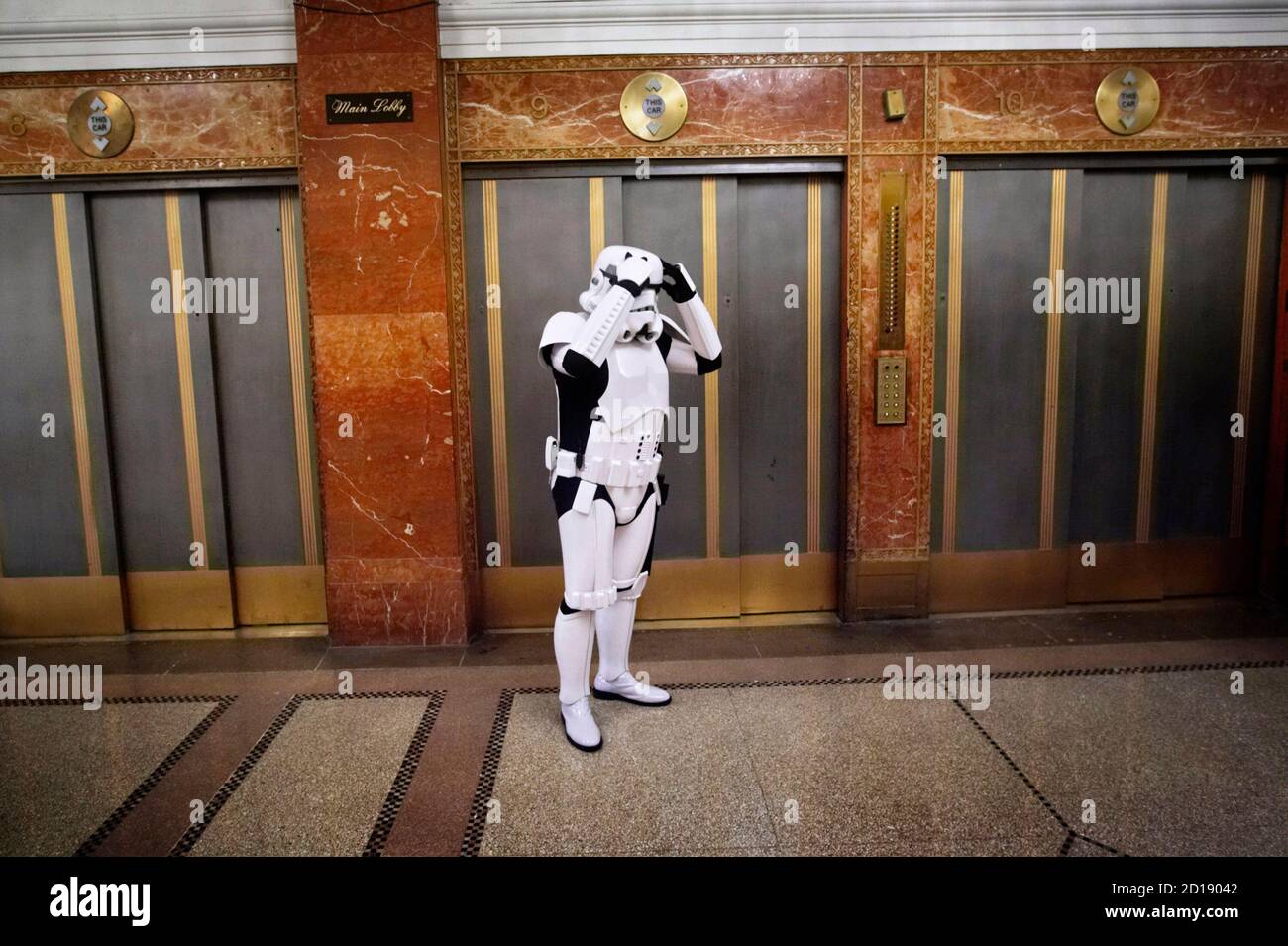 A man dressed as a character from the movie 'Star Wars' waits for an elevator in the lobby of the Hotel Pennsylvania in New York November 17, 2007. The hotel and adjacent Penn Plaza Pavillion are hosting a three day Big Apple Comic Book, Art, Toy & Sci-Fi Expo, billed as the oldest and longest running Comic, Art and Toy, Sci-Fi  show of its kind in New York.  REUTERS/Jacob Silberberg (UNITED STATES) Stock Photo