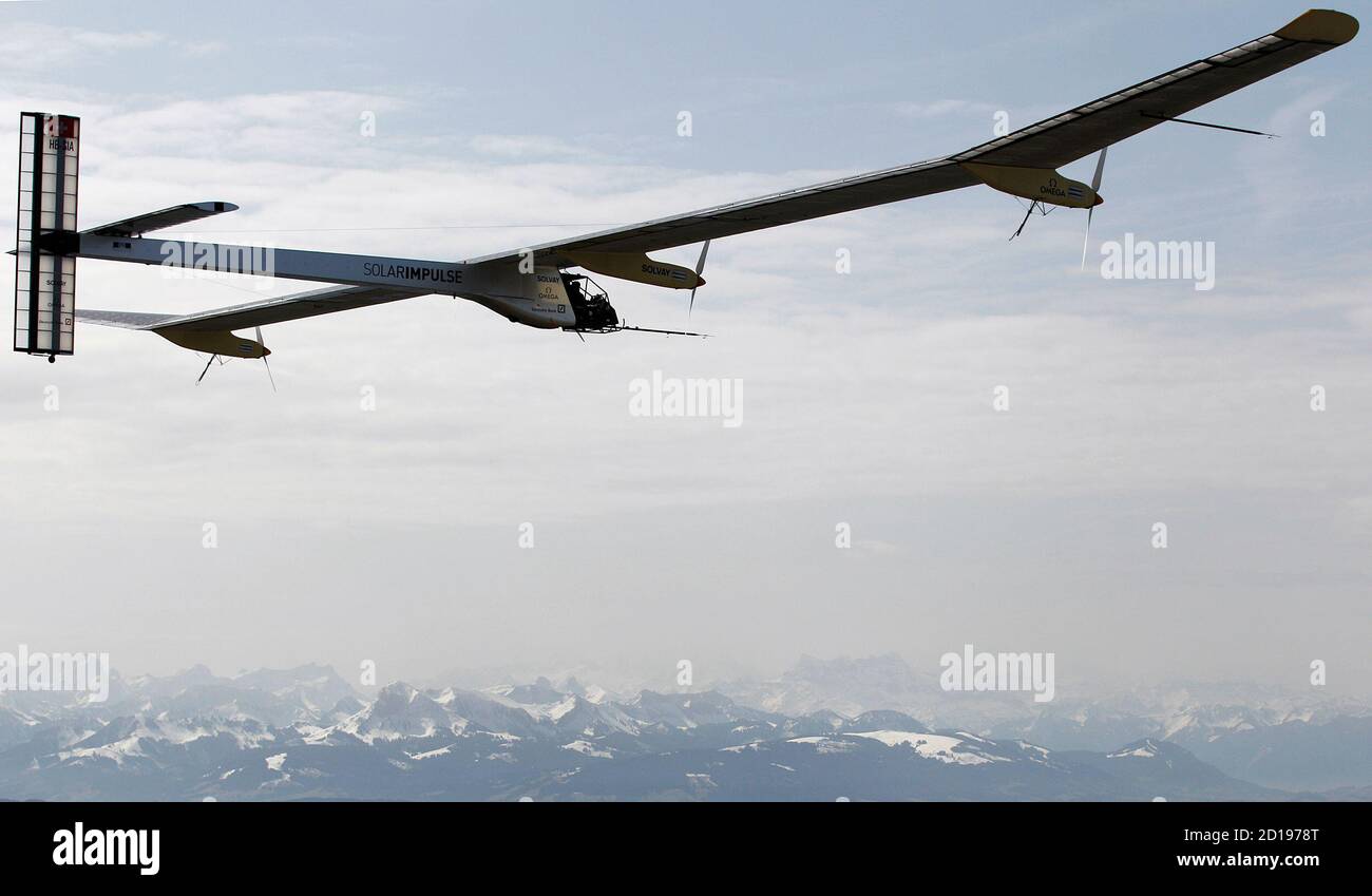 German test pilot Markus Scherdel steers the solar-powered Solar Impulse  HB-SIA prototype airplane during his first flight in front of the Swiss  Alps April 7, 2010. The propeller plane, with a 61
