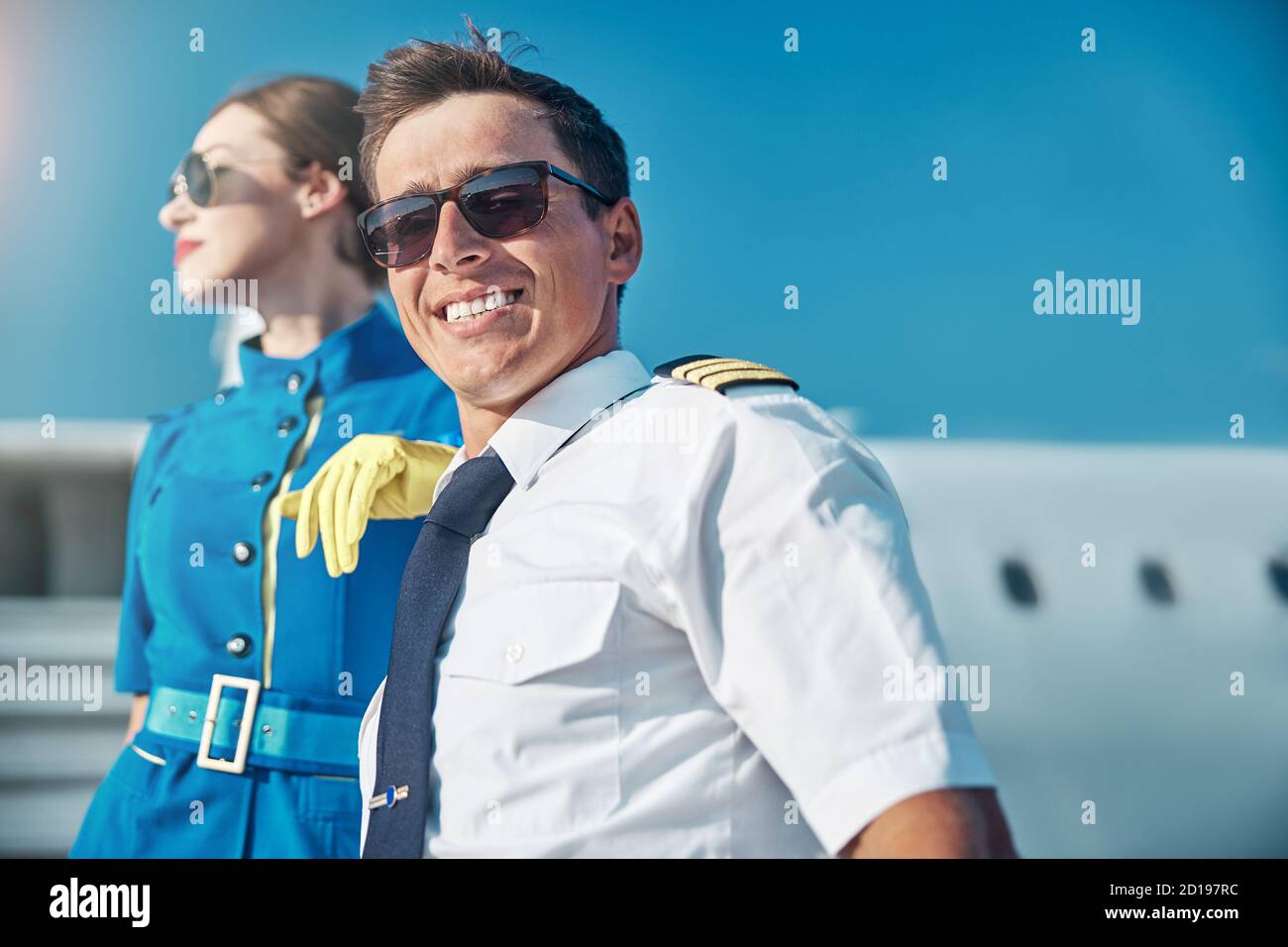 Well Rested Pilots Happy young pilot resting after flight with colleague outdoors Stock ...