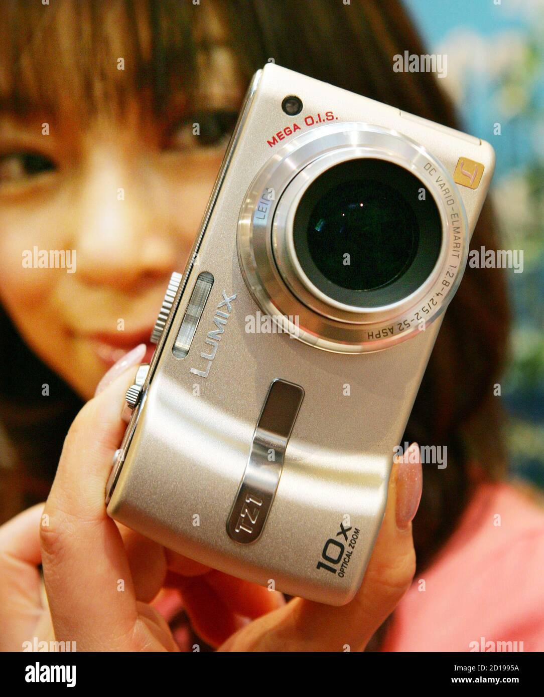 Bekentenis Distilleren eetlust Japanese model Rina Matsuda presents Panasonic's new "LUMIX" digital still  camera DMC-TZ1 at an unveiling in Tokyo February 14, 2006. The five- megapixel camera, manufactured by Matsushita Electric Industrial Co., is  equipped with