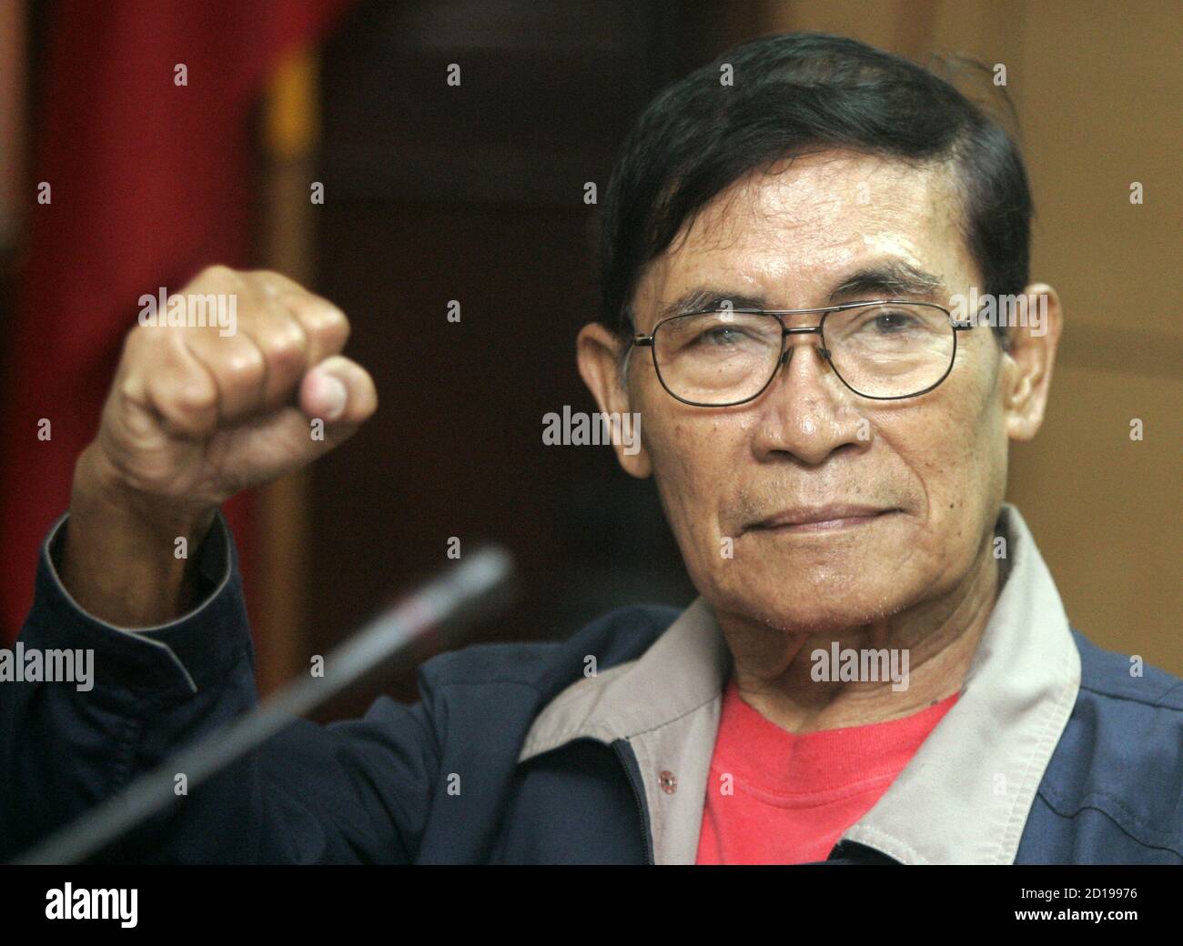 Arrested leftist congressman Crispin Beltran gestures during an inquest at Camp Crame, the Philippine National Police headquarters in Manila February 27, 2006. The Philippines state prosecutor said on Monday that police had filed cases against 16 people, including soldiers and four leftist members of Congress, over a failed attempt to overthrow [President Gloria Macapagal Arroyo.] Stock Photo