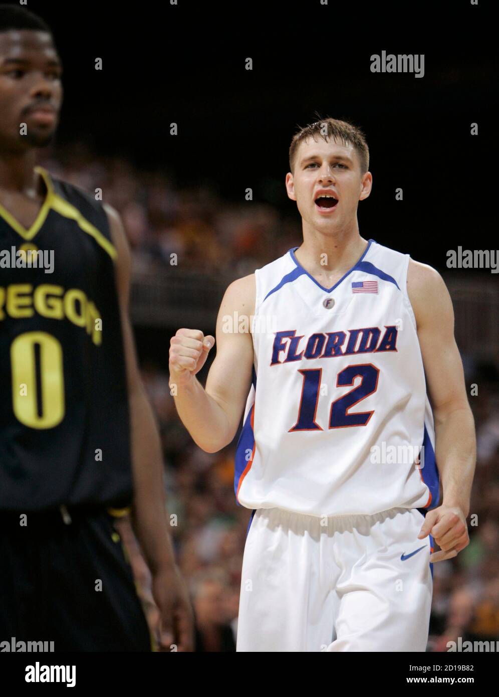 University of Florida Gators' Lee Humphrey (R) celebrates after drawing a  foul beside University of Oregon Ducks Aaron Brooks in their NCAA men's  Midwest Regional final basketball game in St. Louis, Missouri
