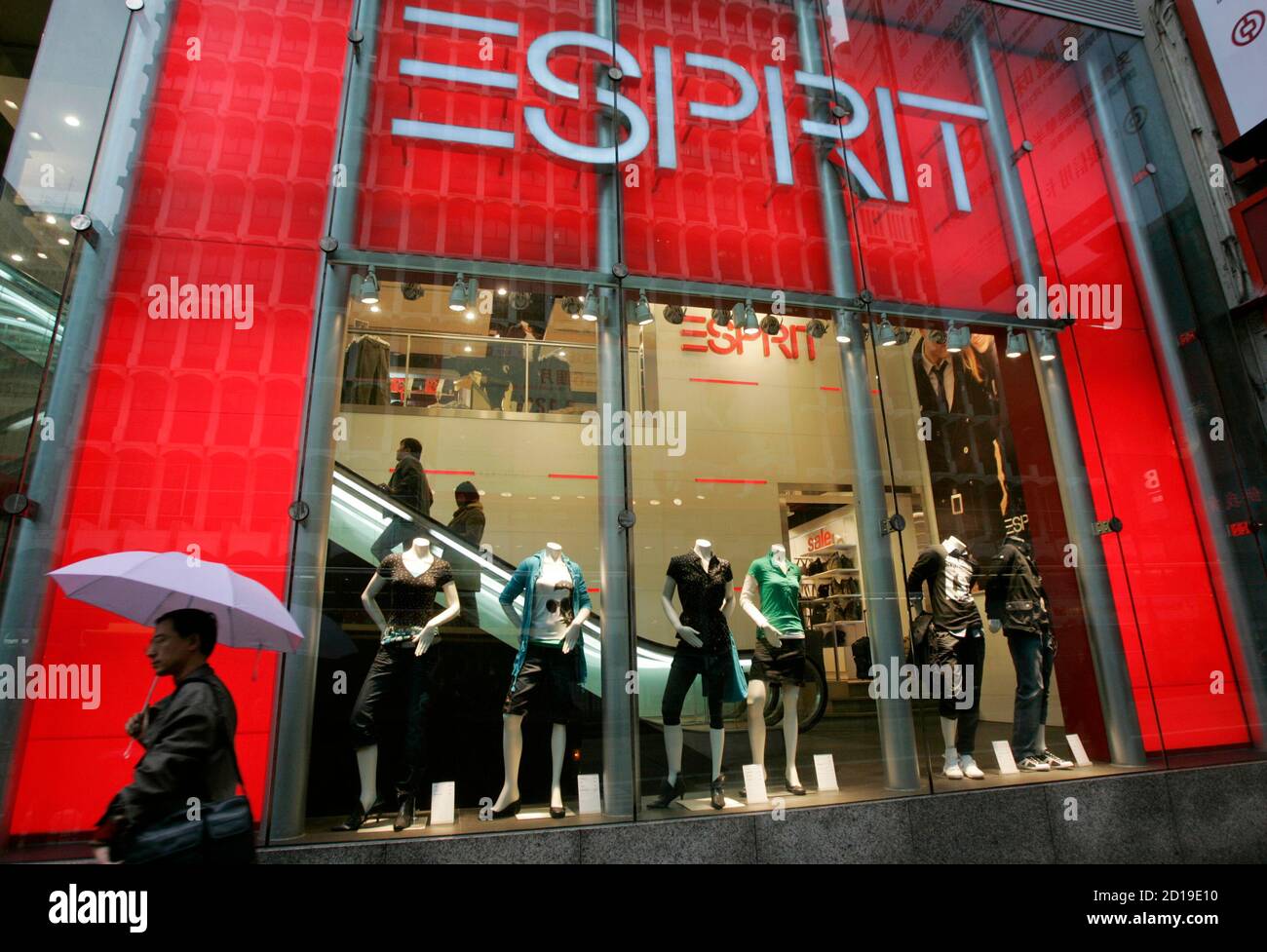 A man walks past an Esprit outlet in Hong Kong January 30, 2008. Esprit  Holdings Ltd posted a 37 percent rise in first-half earnings, slightly  better than forecast, on robust sales growth