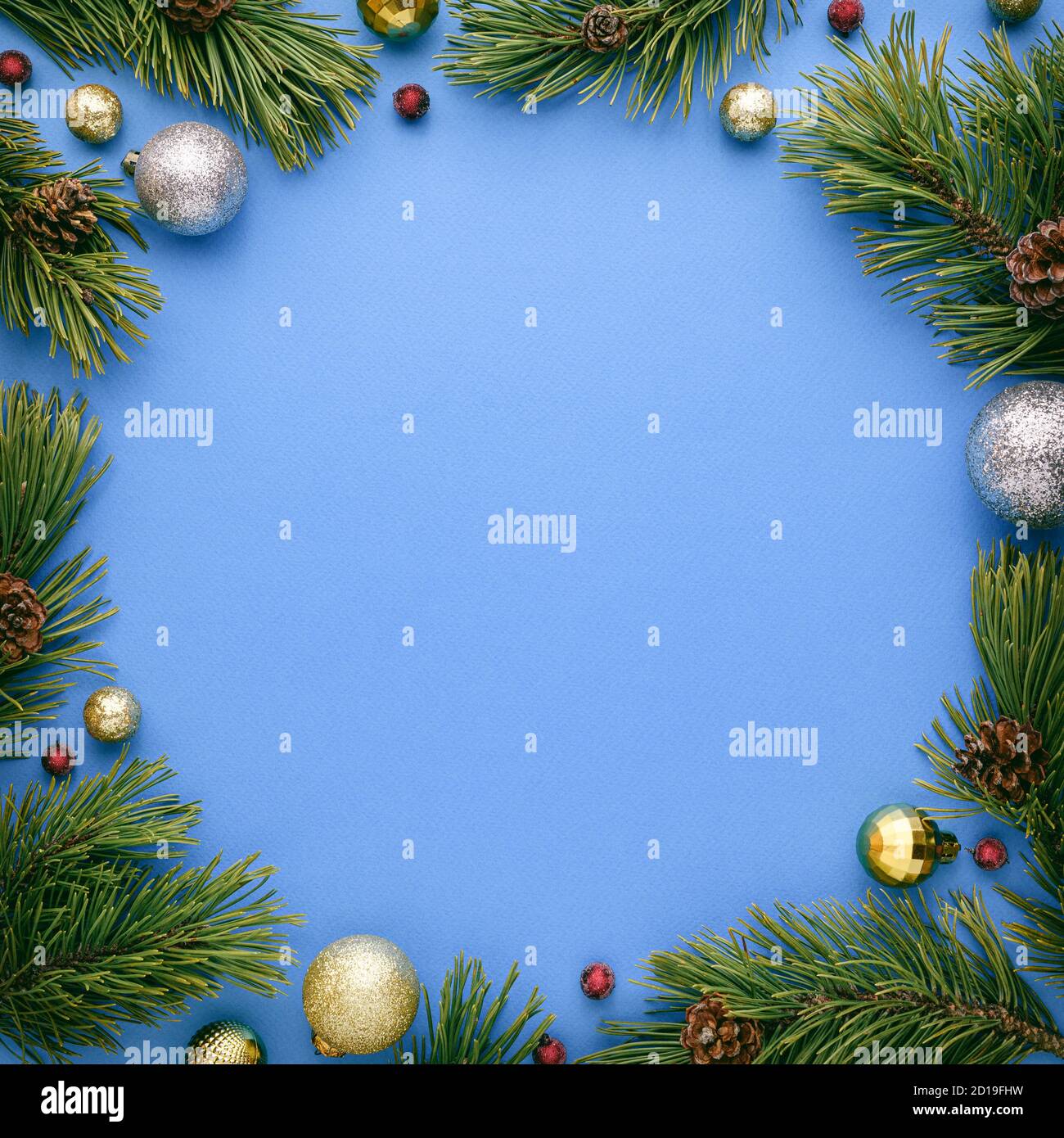 Christmas card with round frame on blue background. New Year banner with copy space. Top view, flat lay Stock Photo