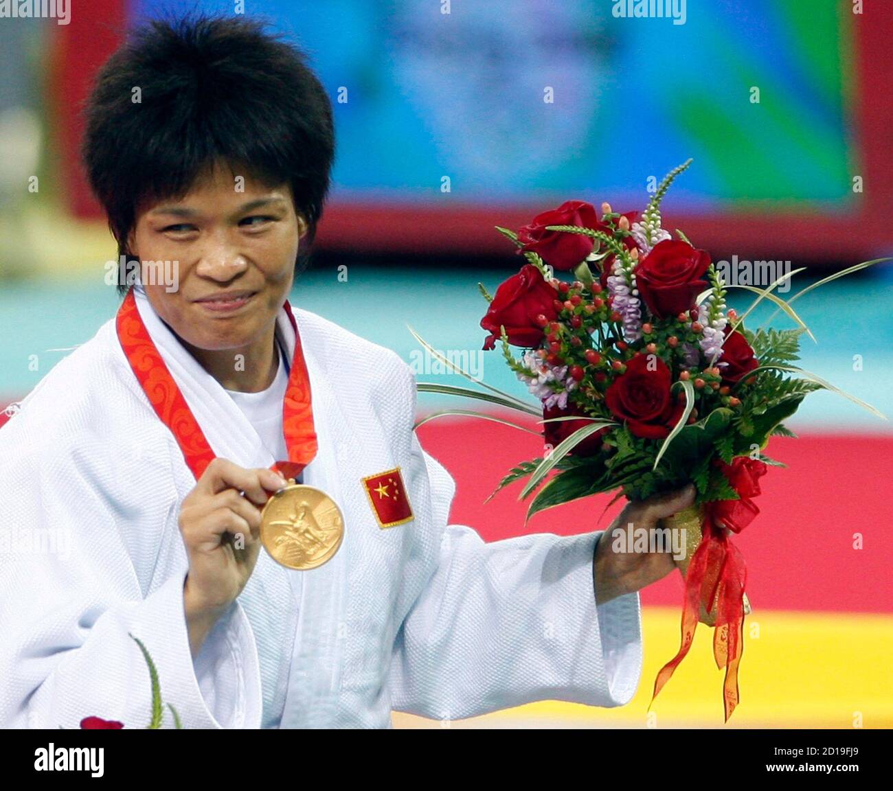 Gold medal winner Xian Dongmei of China holds her medal on podium