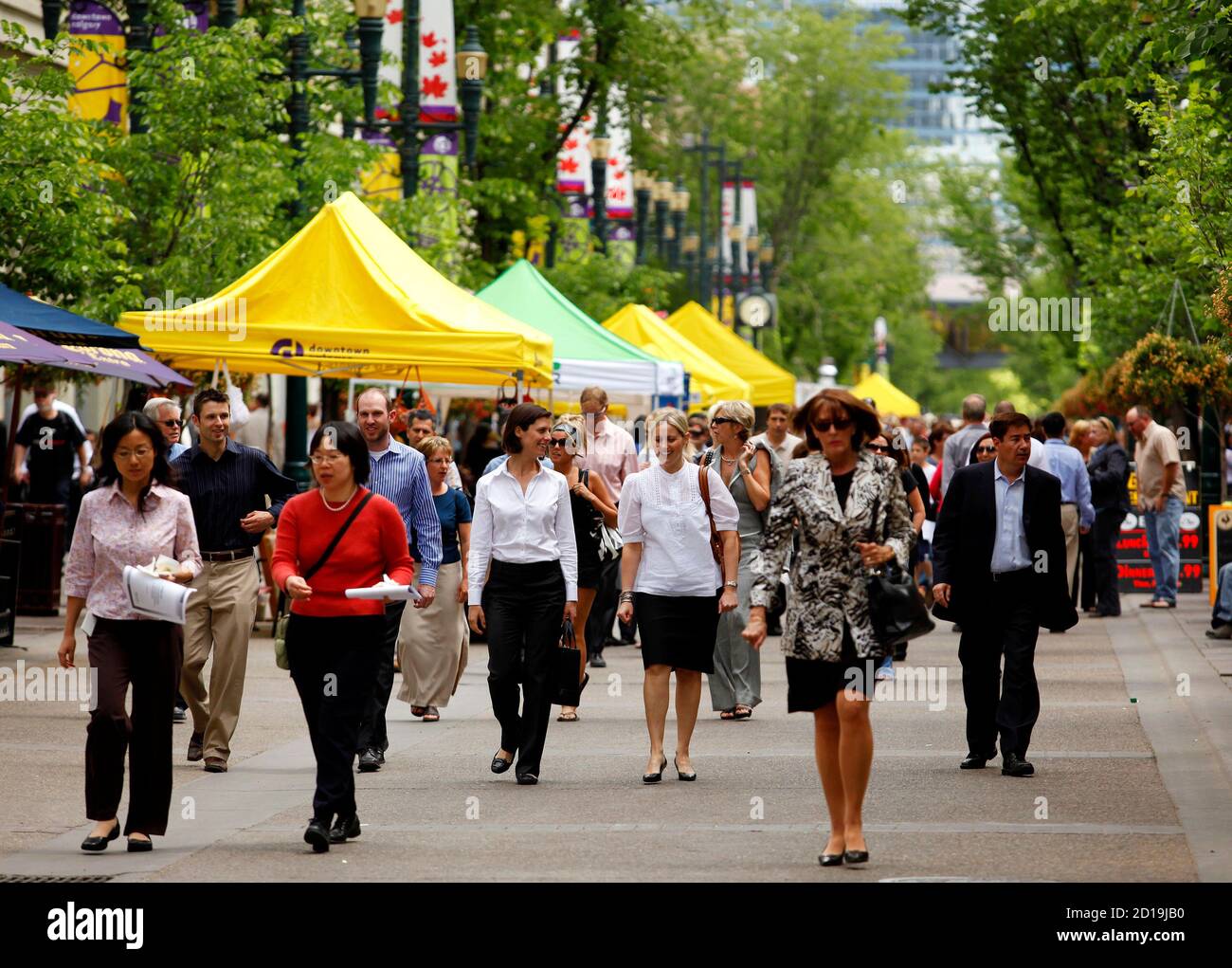 People walk down the historical Stephen Avenue Walk in the heart of  downtown Calgary, Alberta, June 17, 2009. Over 5,000 people can be walking  down the closed off street during peak times,