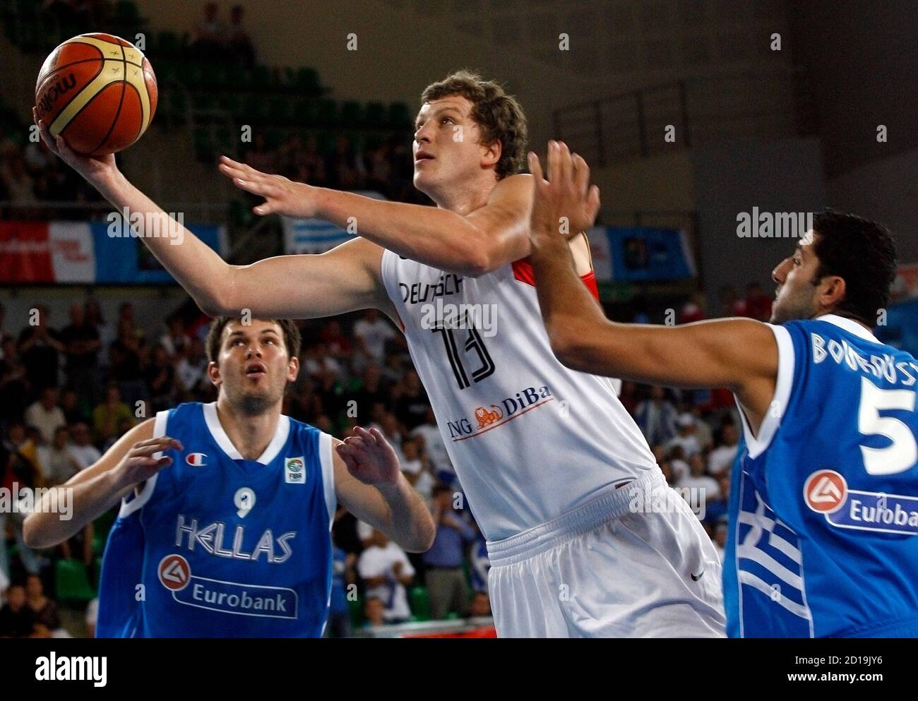 Patrick Femerling of Germany (C) goes for a basket against Ioannis Bourousis  (R) and Antonios Fotsis of Greece during their FIBA EuroBasket 2009  Qualifying Round Group E basketball game in Bydgoszcz September