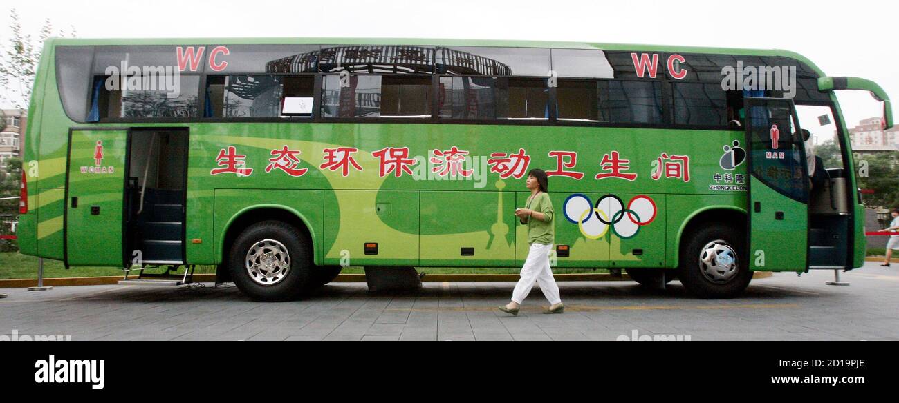 A woman alights from an ecological and environmental friendly mobile toilet bus, during the Saving Water Toilet Exhibition for the Beijing Olympics in Beijing June 7, 2006.  The exhibition showcased a range of prototype urinals, bowls, and traditional Asian crouching platforms -- all aimed at having a more positive impact on the environment.  REUTERS/Claro Cortes IV   (CHINA) Stock Photo