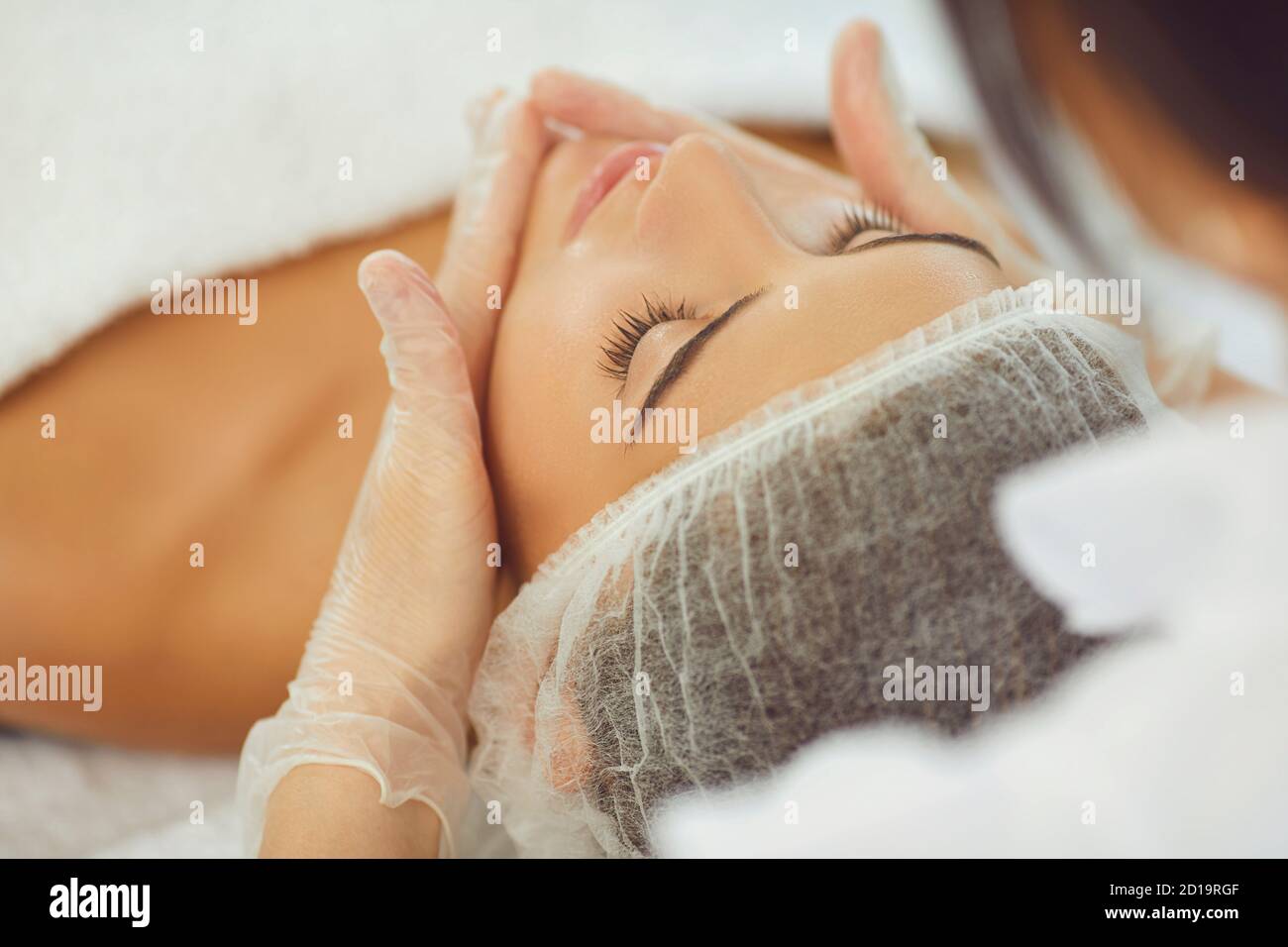Woman face skin massage treatment in cosmetic spa beauty salon Stock Photo