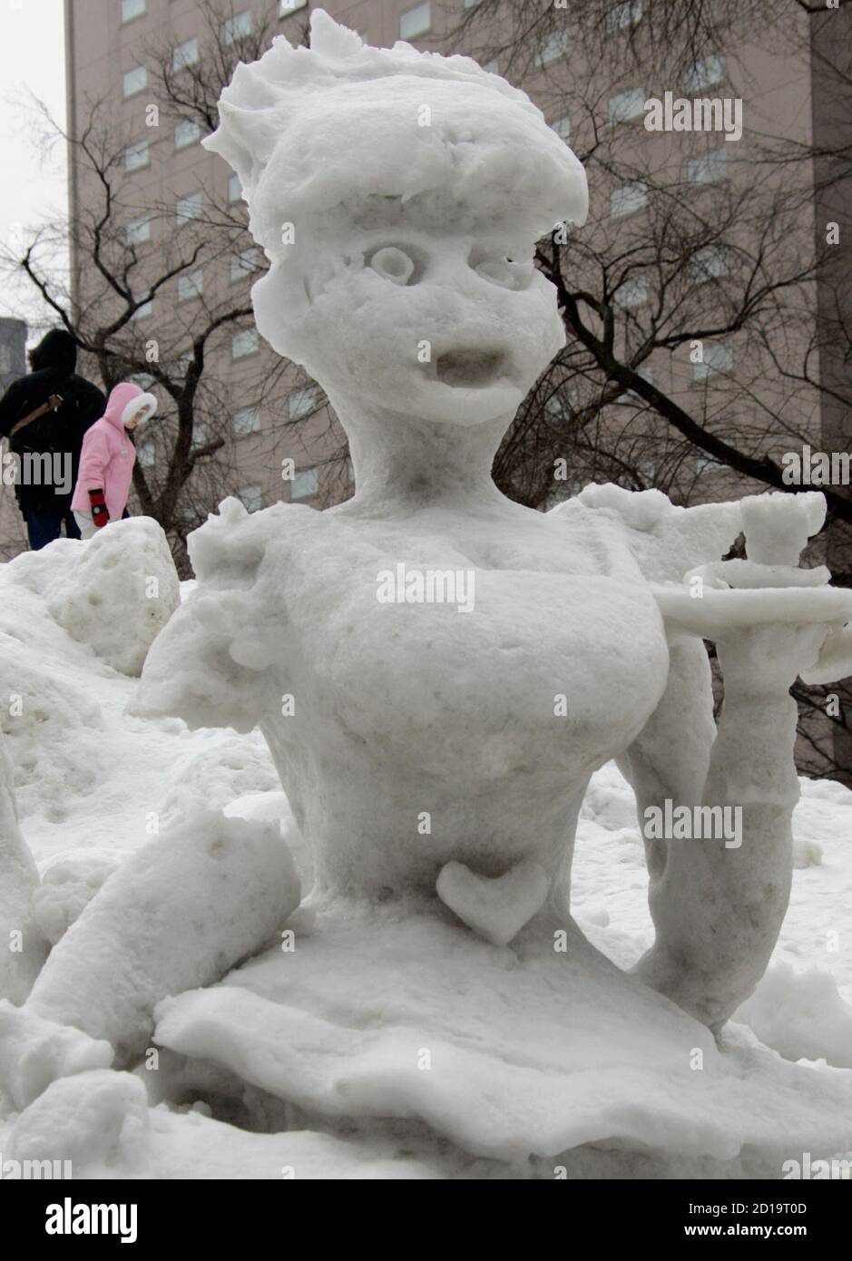 A partially melted mermaid-shaped snow sculpture is displayed at the  Sapporo Snow Festival in Sapporo, northern Japan February 6, 2007.  Undaunted by unseasonably high temperatures and rain, the Sapporo Snow  Festival, one