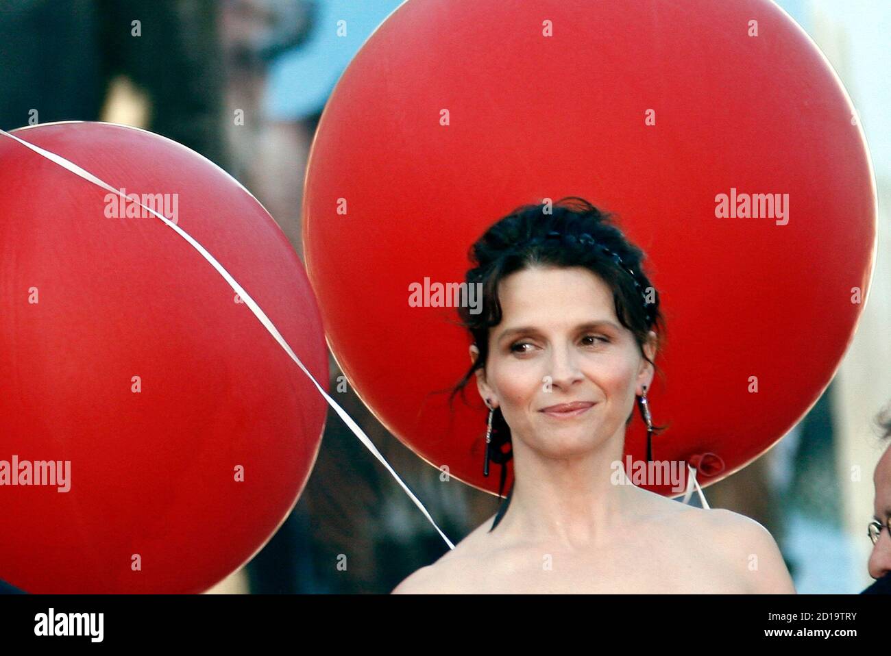 French actress Juliette Binoche arrives for an evening gala screening of  Taiwanese director Hou Hsiao Hsien's film "Le Voyage du Ballon Rouge" which  opens the "Un Certain Regard" competition at the 60th
