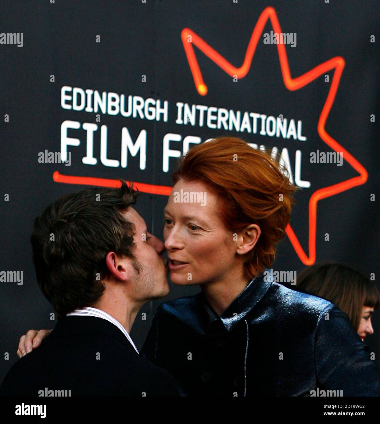 British actor Jamie Bell (L) kisses actress Tilda Swinton on the red carpet  at the premiere of the movie "Hallam Foe" on the opening night of the 61st  Edinburgh International Film Festival