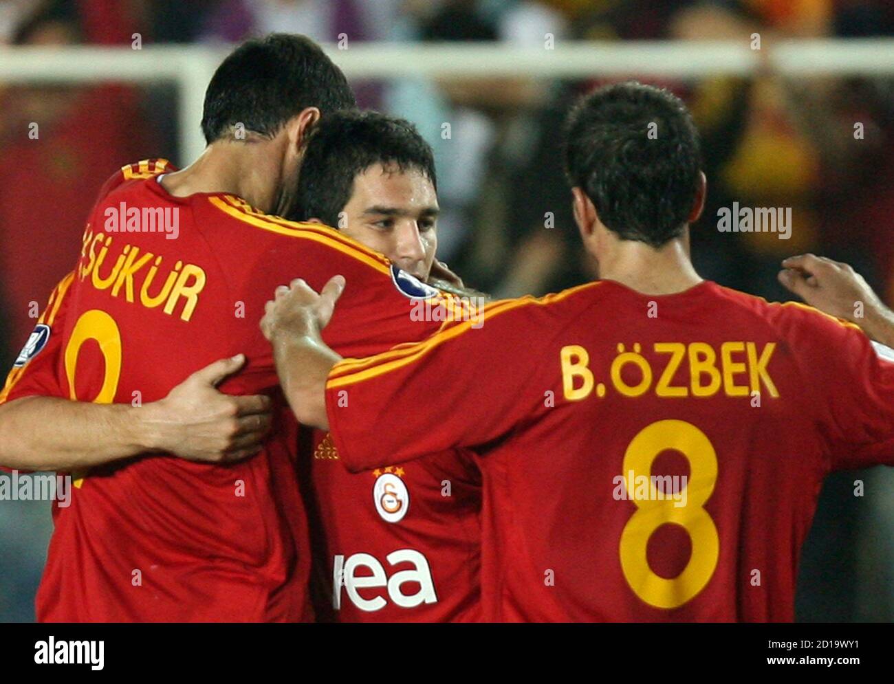 Galatasaray S Arda Turan C Is Hugged By Teammates Hakan Sukur L And Baris Ozbek After Scoring Against Sion During Their Uefa Cup First Round Second Leg Soccer Match At Ali Sami Yen