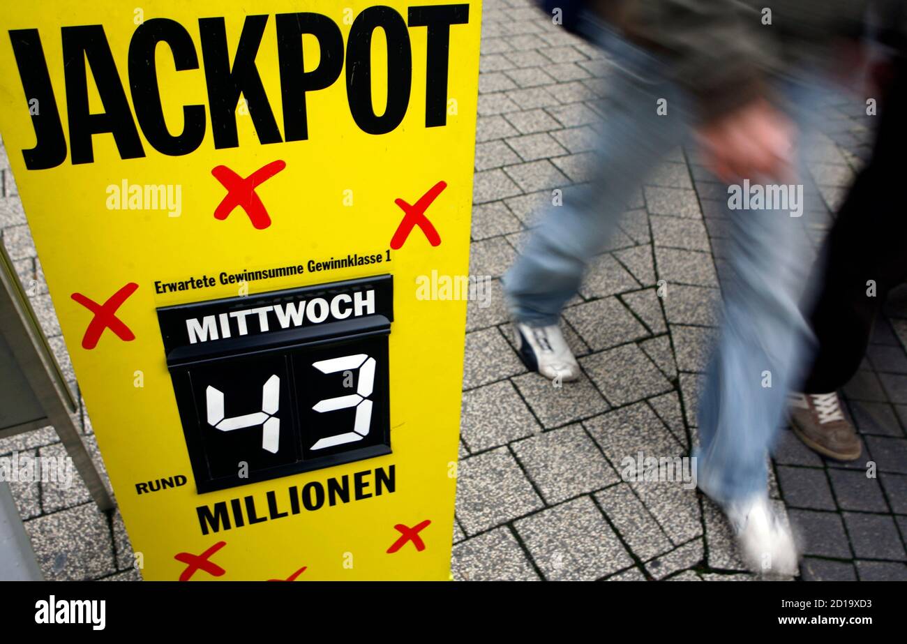 Pedestrians pass in front of a Lotto receiving office decorated with  advertising posters in Bensheim some 50 kilometres south of Frankfurt  December 4, 2007. This Wednesday the German public lottery 'Lotto' will