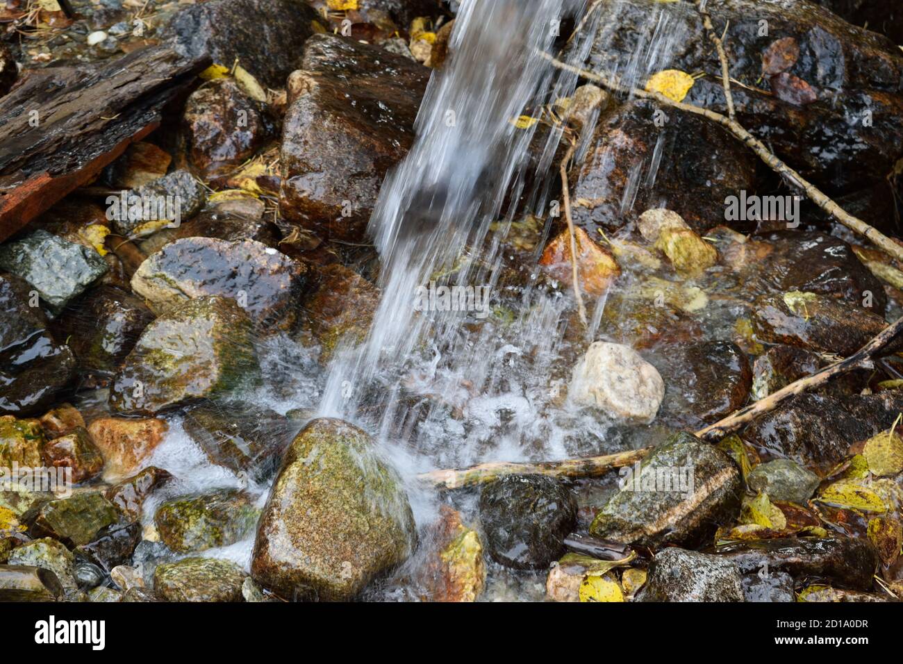 Water Falling from a Pipe Onto Stones and Autumn Leaves Stock Photo - Alamy