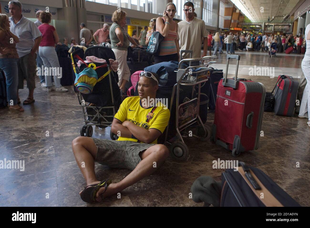 Passengers, who had an XL Airways flight cancelled, wait for news at the  airport in Tenerife in Spain's Canary Islands September 12, 2008. Britain's  third largest package holiday operator, XL Leisure Group,