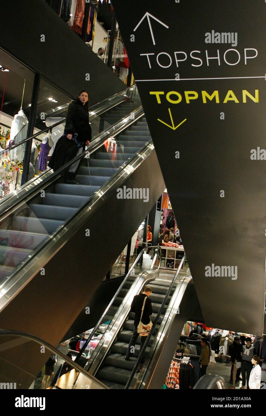 Shoppers ride on escalators in the new Topshop and Topman clothing store in  New York April 2, 2009. Topshop, Britain's trendy mass-market fashion  retailer, could eventually have about 15 stores in the