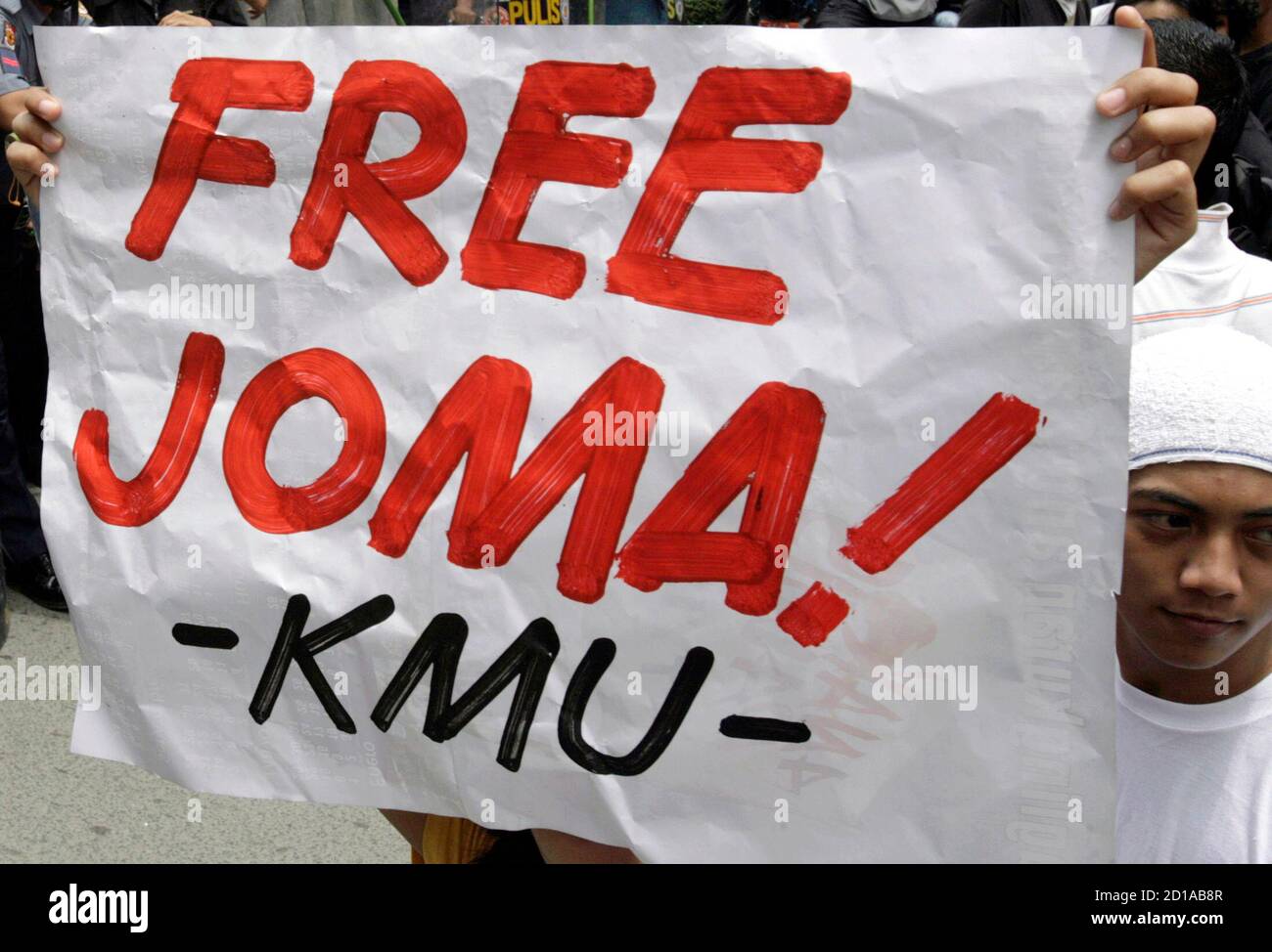 A student protester holds a placard as he tries to reach the embassy of the  Netherlands during a protest march in Makati City, Metro Manila August 29,  2007, against the arrest by