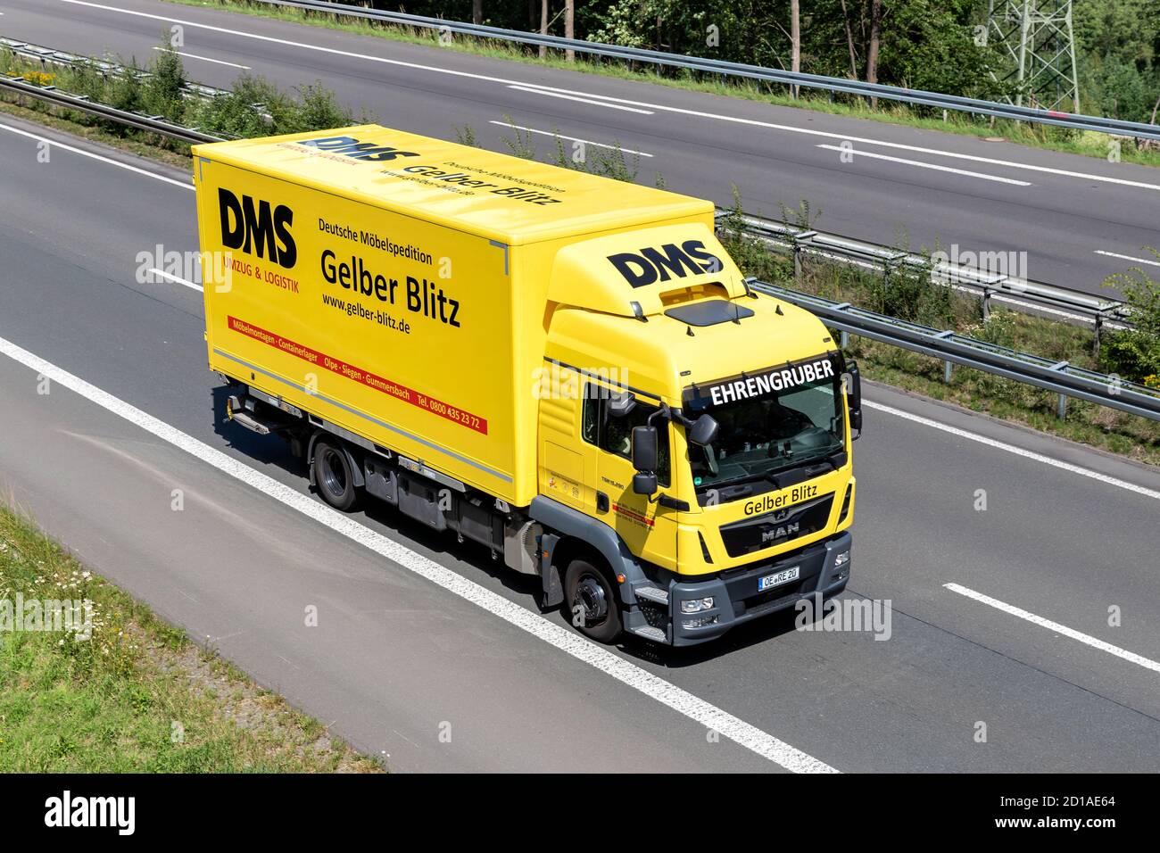 DMS Gelber Blitz MAN TGM truck with swop body on motorway. Stock Photo