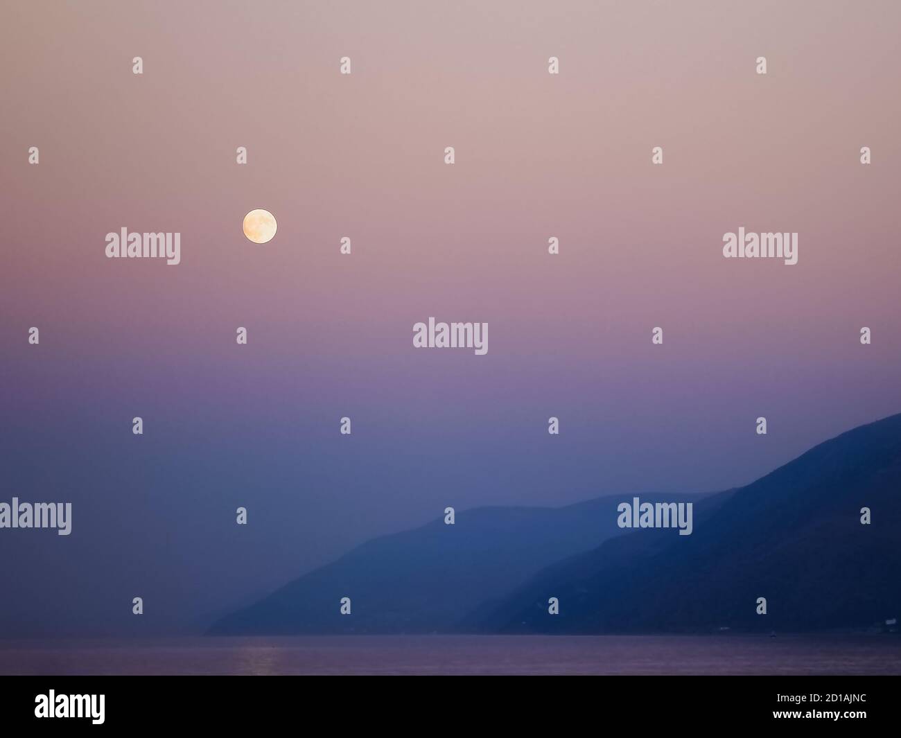 The full moon and a purple sky above Rif mountains in Morocco Stock Photo