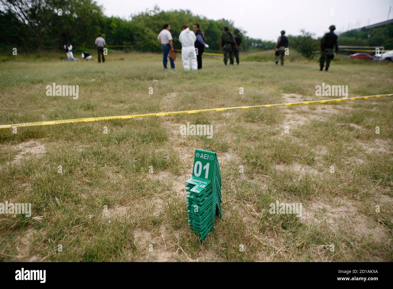 Evidence markers are seen as soldiers and forensic personnel ...