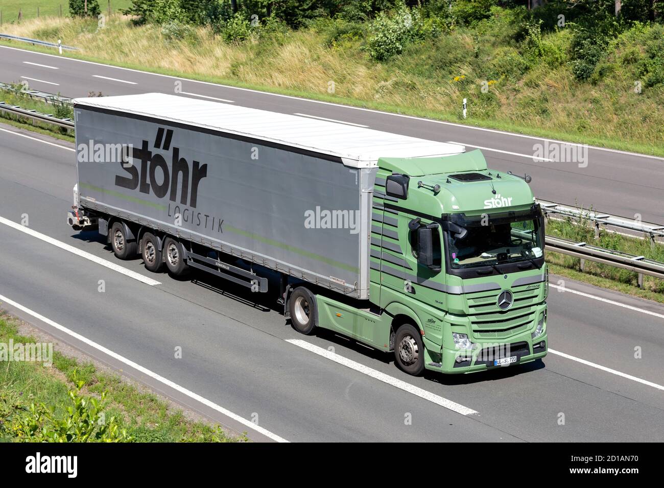 Stöhr Logistik Mercedes-Benz Actros truck with curtainside trailer on motorway. Stock Photo