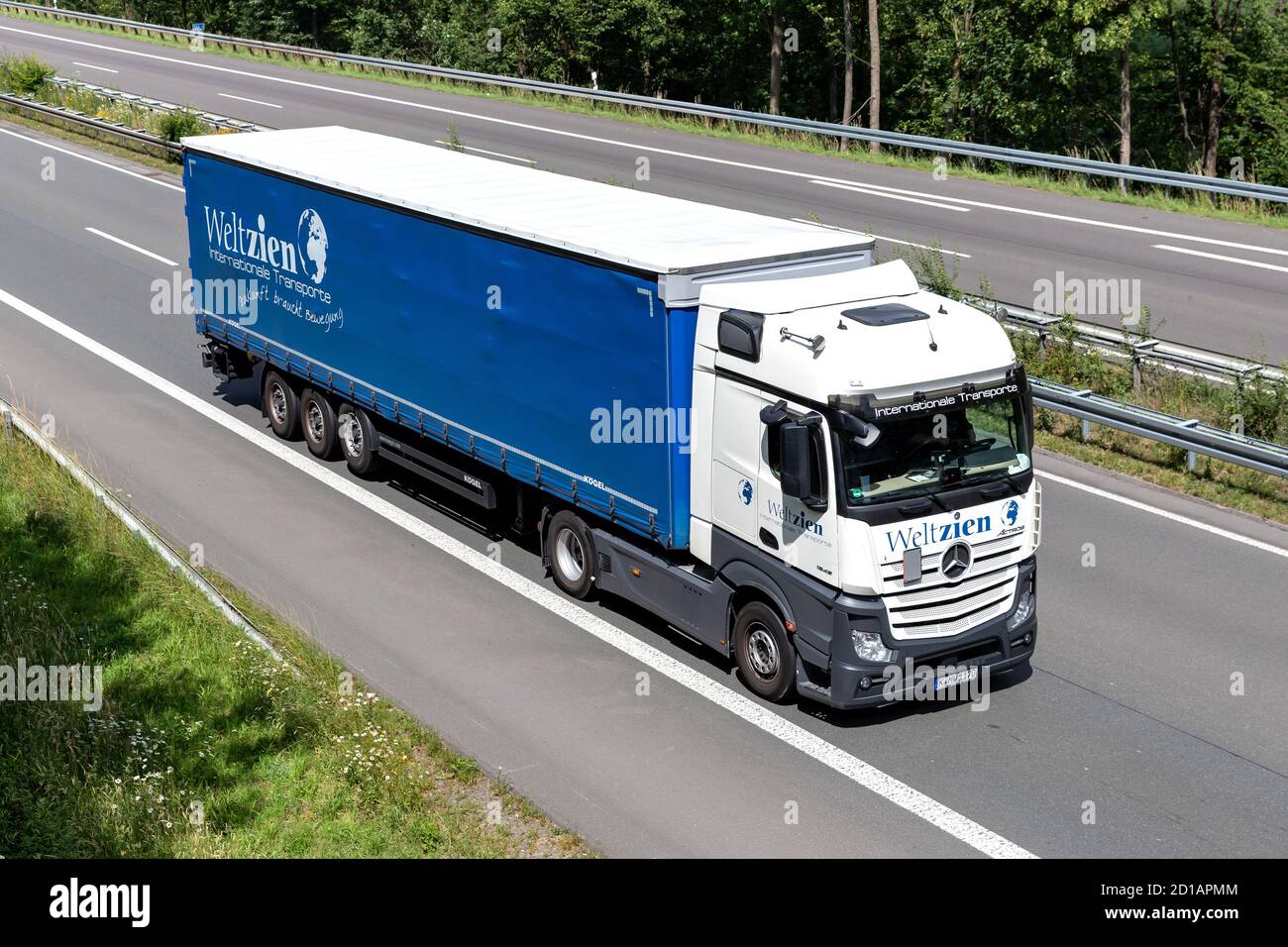 Weltzien Mercedes-Benz Actros truck with curtainside trailer on motorway. Stock Photo