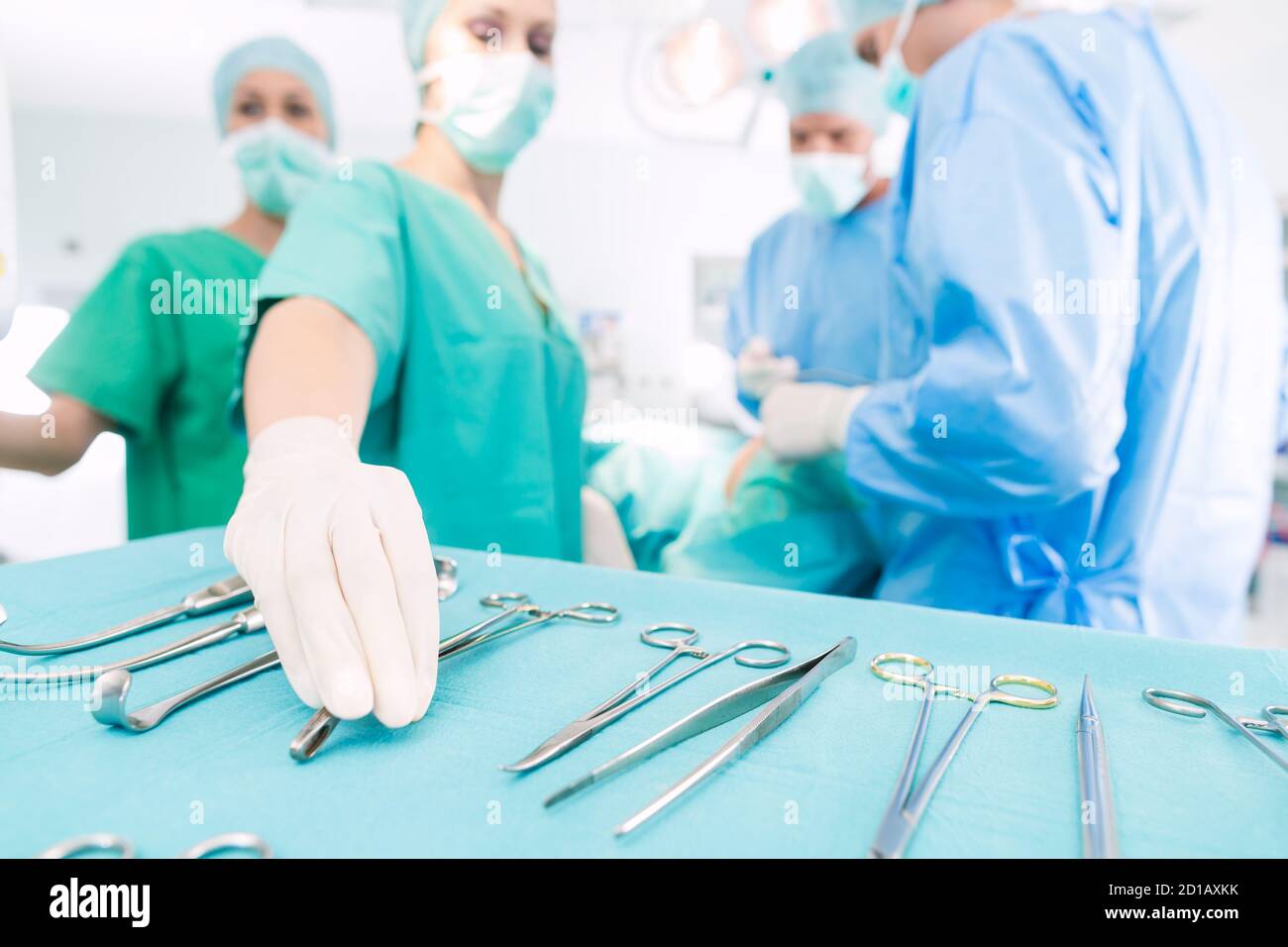 Surgeons operating patient in operating room Stock Photo