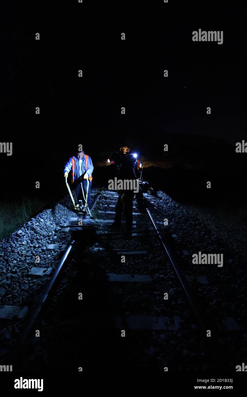Rail destressing with power wrench before exothermic welding at night
