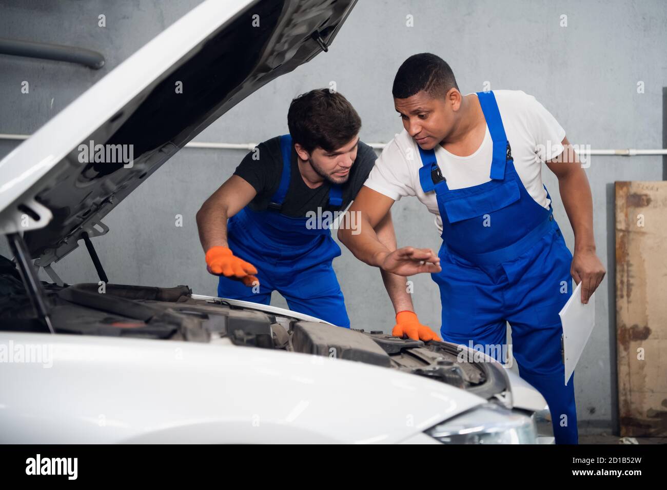 Male repairer checking automobile motor hi-res stock photography and ...