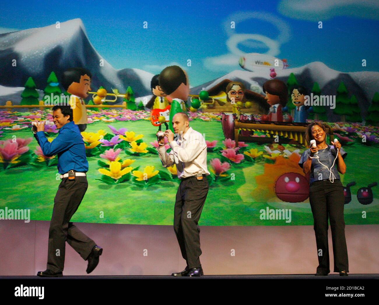 Nintendo employees perform a song together as they demonstrate playing the  new game 'Wii Music' at the Nintendo E3 media briefing in Hollywood,  California July 15, 2008. REUTERS/Fred Prouser (UNITED STATES Stock