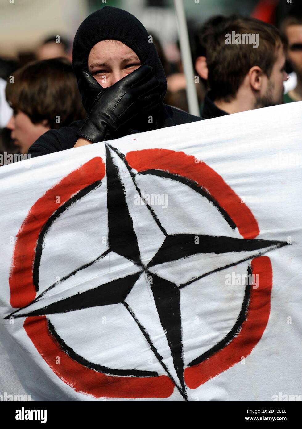 A protestors covers his face during an anti-NATO demonstration in Baden- Baden, April 3, 2009. The North Atlantic Treaty Organisation (NATO)  military alliance is celebrating its 60th anniversary at a summit co-hosted  by