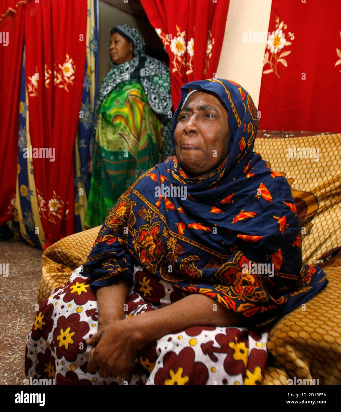Kalathoumi Athoumani, grandmother of 14-year-old Franco-Comoran girl Bahia Bakari, the sole survivor of the Yemenia Airbus A310-300 plane crash, sits inside her house in Nioumazadha village in Bambao area, about 15 km (9 miles) south of Comoros' capital Moroni, July 3, 2009. The sole survivor of the Yemeni jet that plunged into the Indian Ocean off the Comoros islands was reunited with her father in France, but rescuers said hopes of another miracle find were all but over. REUTERS/Thomas Mukoya (COMOROS DISASTER TRANSPORT) Stock Photo