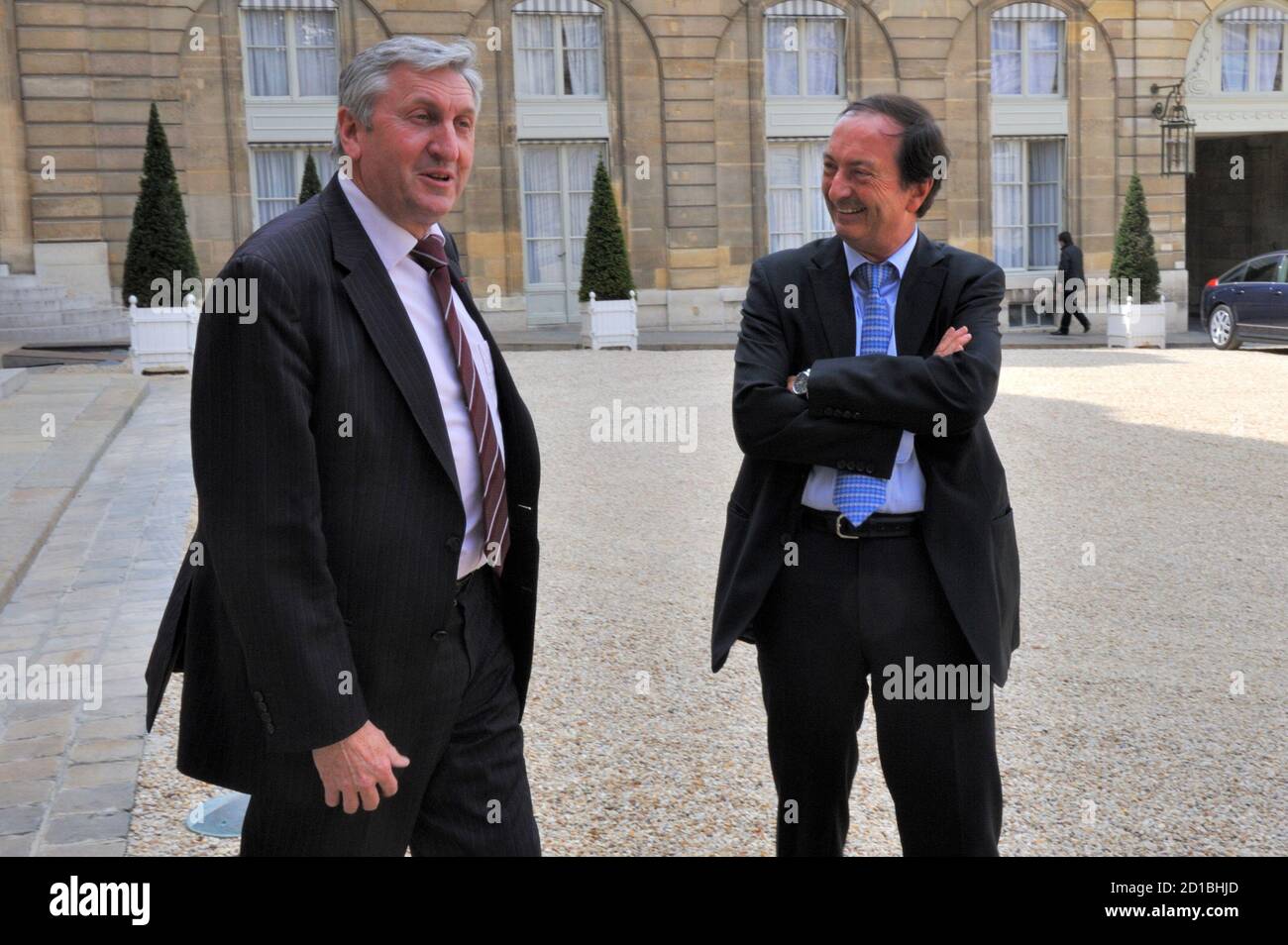 French retail group Leclerc CEO Michel-Edouard Leclerc (R) speaks with  French farmer Union FNSEA leader Jean-Michel Lemetayer as they arrive at  the Elysee Palace in Paris to attend a meeting between retailers,