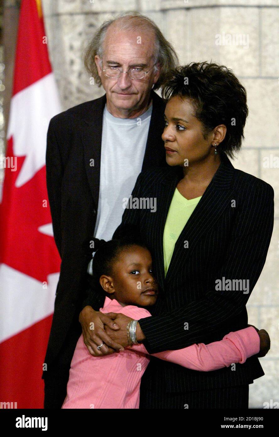 Canadian Governor General designate Jean listens with her husband Lafond  and daughter during news conference on Parliament Hill in Ottawa. Canadian  Governor General designate Michaelle Jean (R) listens with her husband Jean- Daniel