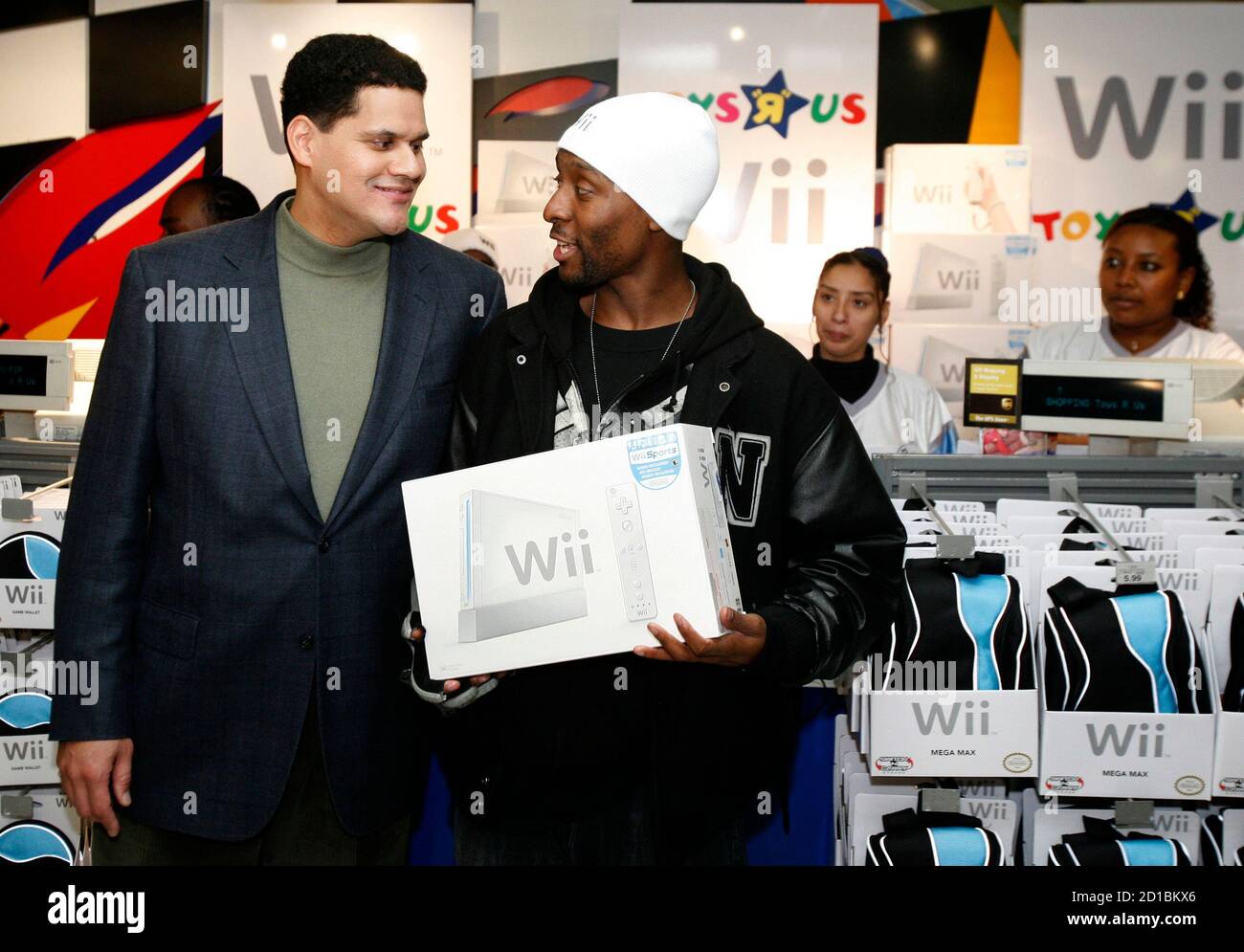 Isiah "Triforce" Johnson (R) talks with Reggie Fils-Aime, president of  Nintendo of America, after being the first customer to purchase a Nintendo  Wii video game system during the official launch of the